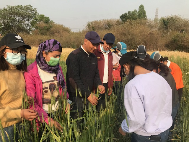 Dhruba Thapa (center) with students in the field