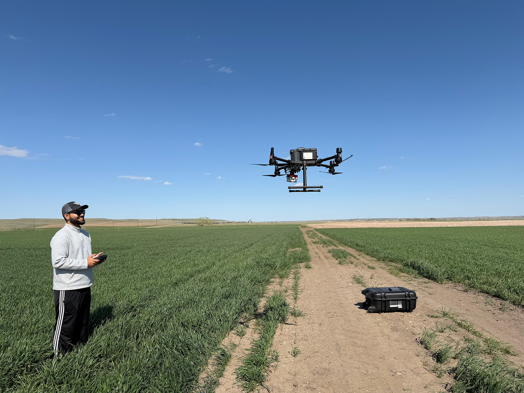 Scientist controls a drone in a field
